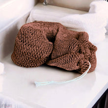African Exfoliating Net Bath Smooth - African Net Sponge in coffee color resting on a bathroom counter.